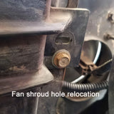 A photo of a fan shroud hole relocation with overlaying text that reads, fan shroud hole relocation in white text. 